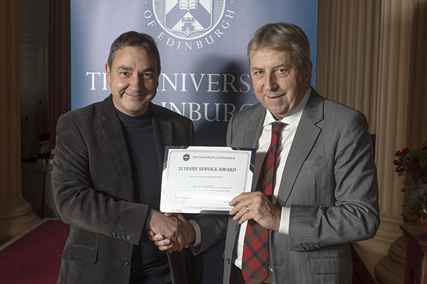 Photograph of Professor David Aspinall receiving a 25 years long service award