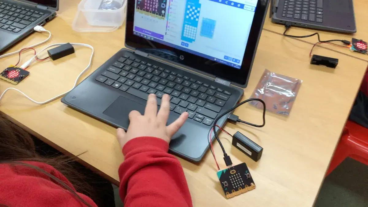 Photo of a child's hand on a laptop keyboard