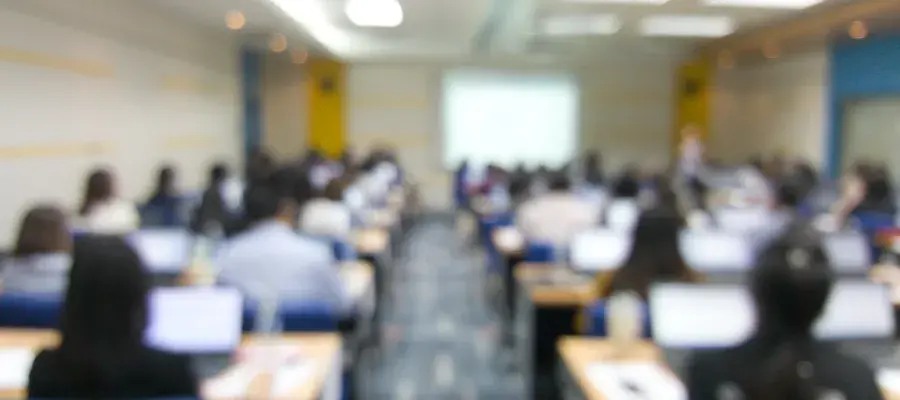 A blurred photo of a teaching room, taken from the back of the room