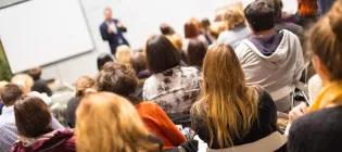 People in a seminar room, photo taken from the back of the room