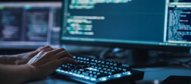 Human hands on computer keyboard