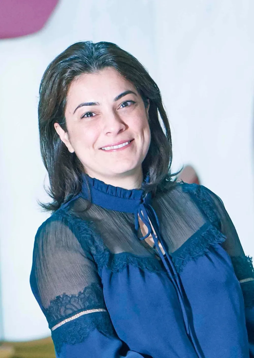 Photo of Elham Kashefi wearing a dark blue blouse with mesh panelling.