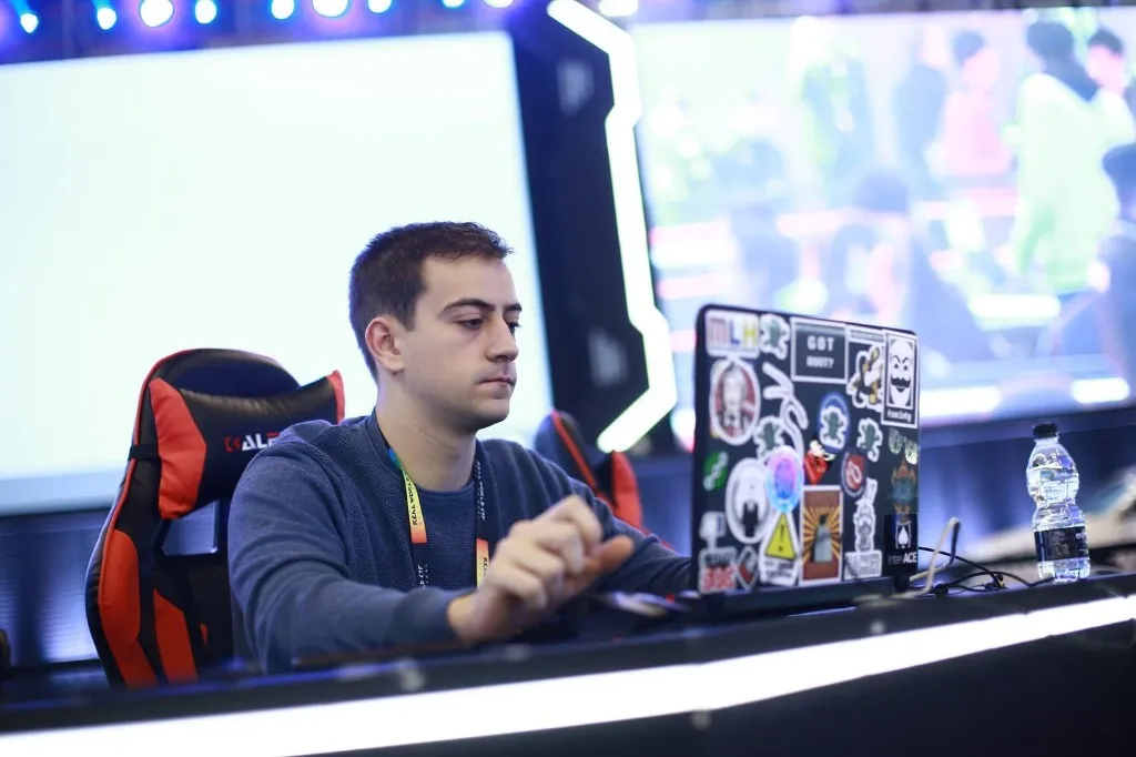 Photo of a young man in front of a computer screen