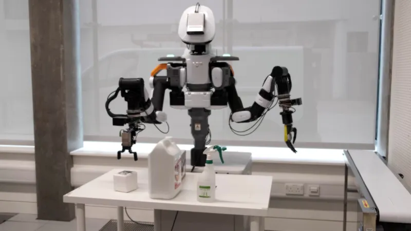 NextageA robot picking an item around obstacles during project demonstration.